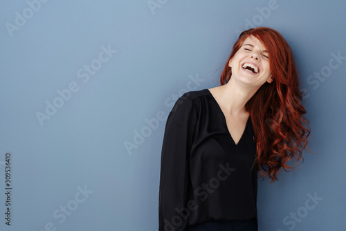 Young woman laughing uproariously at a joke