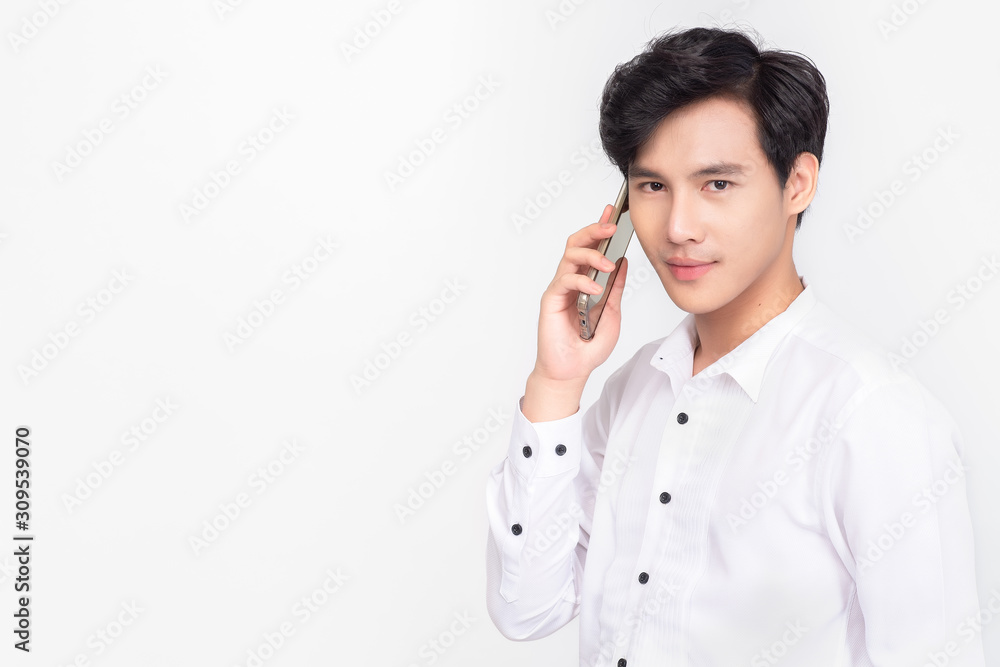 Portrait of asian business man talking on smart phone on white background; Free from copy space. Young business man holding cellphone. Portrait of asian business man talking on smart phone on white background; Free from copy space. Young business man holding cellphone.