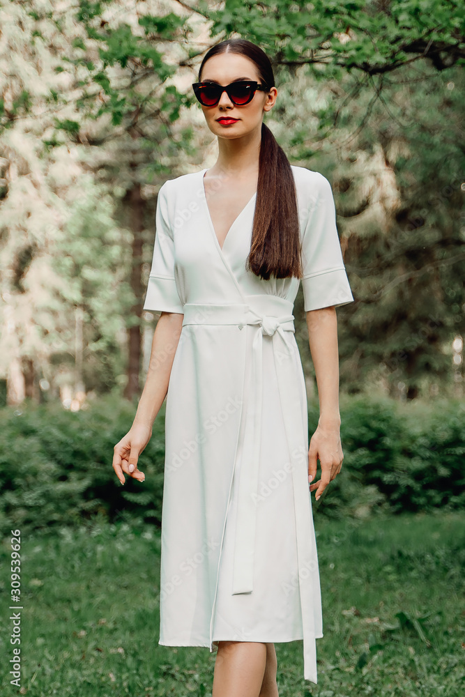 The girl in the white dress. Walk in the Park. Long-haired brunette. Female portrait. A young woman with dark glasses. The girl in the white dress. Walk in the Park. Long-haired brunette. Female portrait. A young woman with dark glasses.