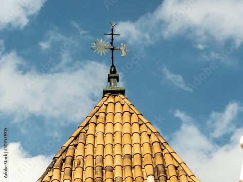 cross on top roof of catholic church in Brazil