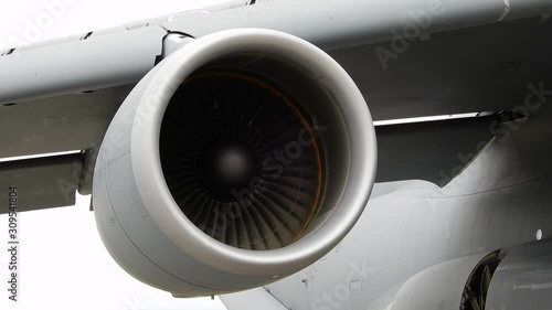 Closeup Of Left Jet Turbine Engine Moving Flying In Sky photo