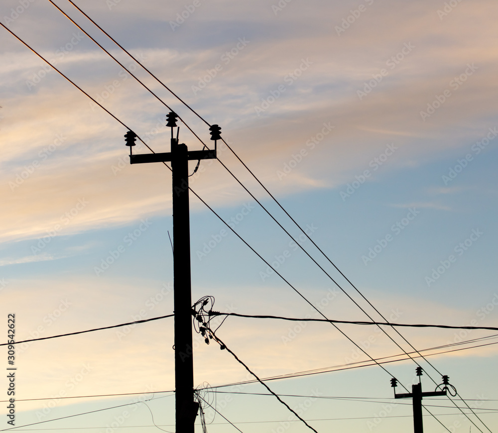 Electric pole with wires on a sunset background Electric pole with wires on a sunset background