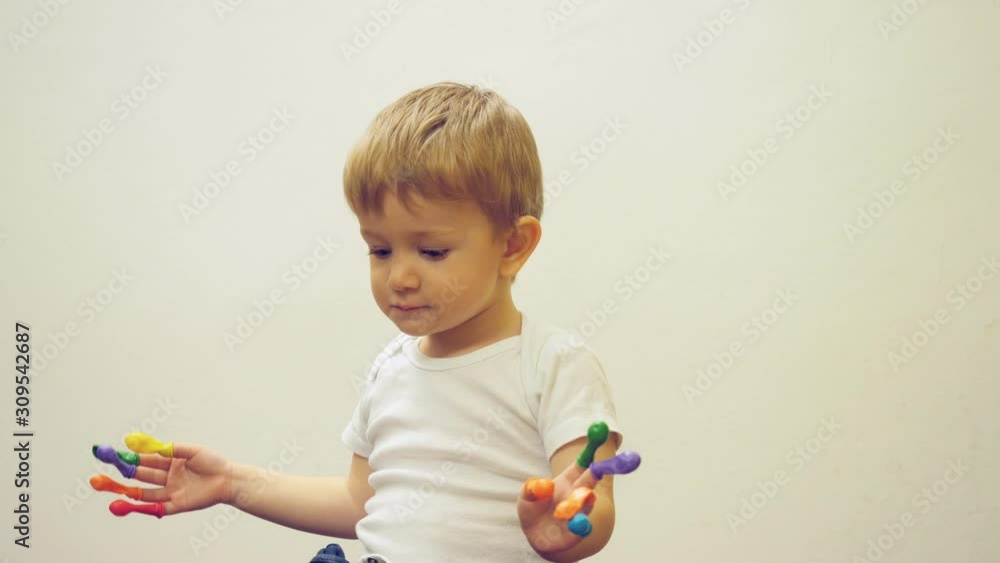 Portrait of blond hair child with blue eyes play with colored balloons Portrait of blond hair child with blue eyes play with colored balloons