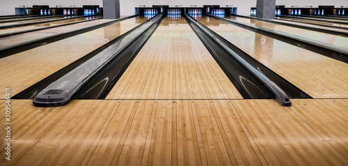 Close up of bowling balls, bowling pins bowling balls in a row.