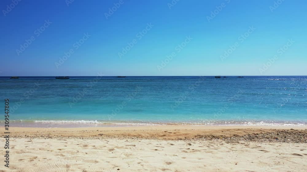 Beach In Bahamas - Waves Calmly Splashing To The Sandy Shore Under The Blue Sky On A Bright Weather - Wide Shot Beach In Bahamas - Waves Calmly Splashing To The Sandy Shore Under The Blue Sky On A Bright Weather - Wide Shot
