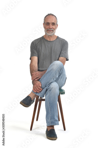 portrait of middle aged man sitting  on white © curto
