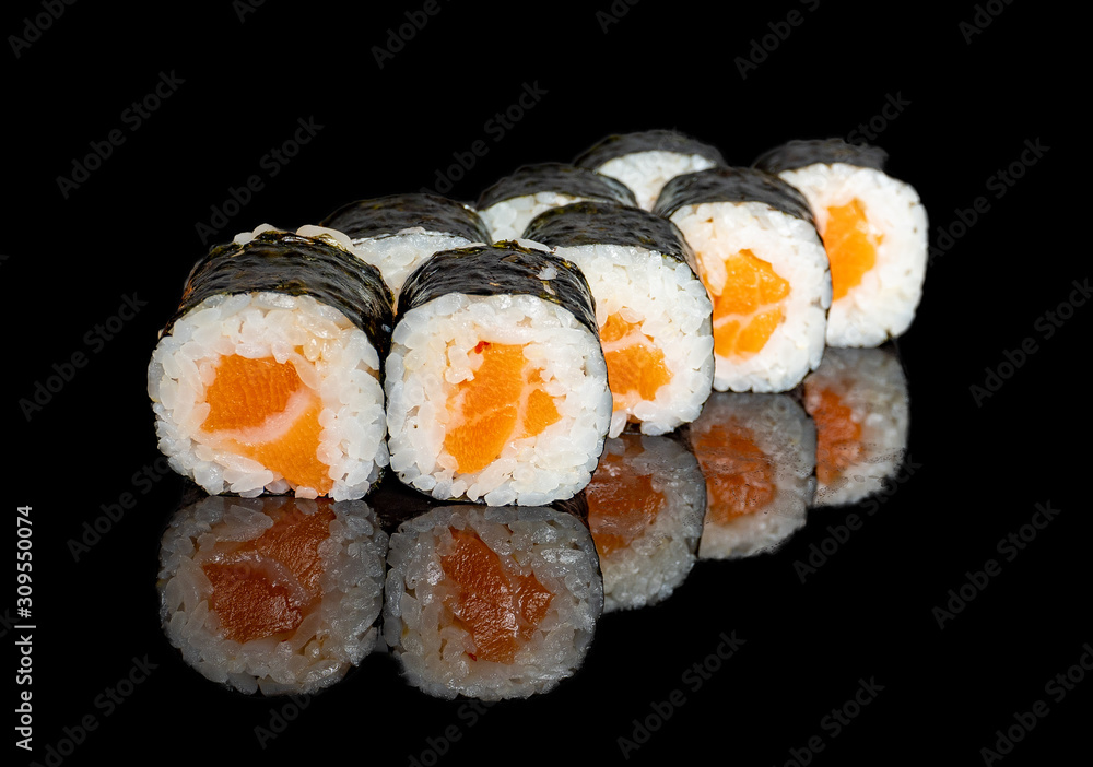 sushi and rolls with different fillings on a black background with reflection sushi and rolls with different fillings on a black background with reflection