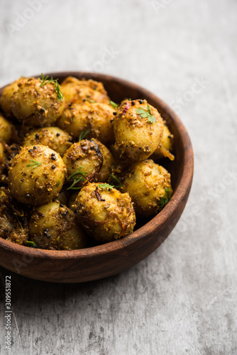 Jeera Aloo - Potatoes Flavoured With Cumin seeds and spices. popular Indian main course recipe. served in a bowl. selective focus