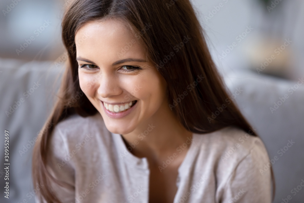 Close up of smiling girl laughing at funny joke Close up of smiling girl laughing at funny joke