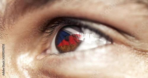 Man with brown eyes in close up, the flag of Czeck republic in iris,  with wind motion. video concept photo