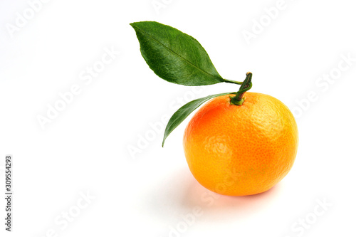 Ripe orange mandarin with a green leaf on a white background