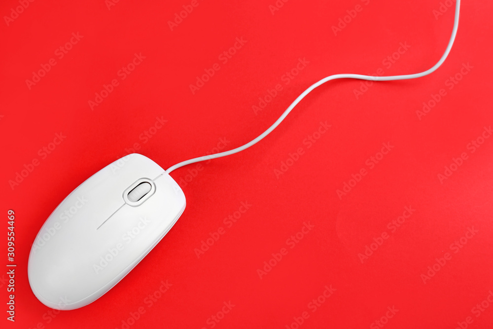 Modern wired optical mouse on red background, top view Modern wired optical mouse on red background, top view