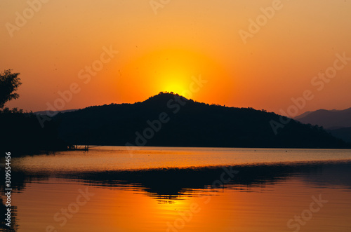 sunset sunrise over river and mountain