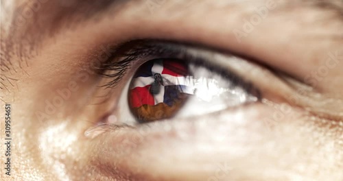 Man with brown eyes in close up, the flag of dominican republic in iris,  with wind motion. video concept photo