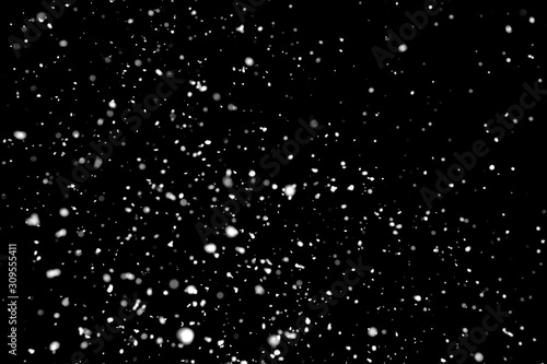 White snow falling down on black background