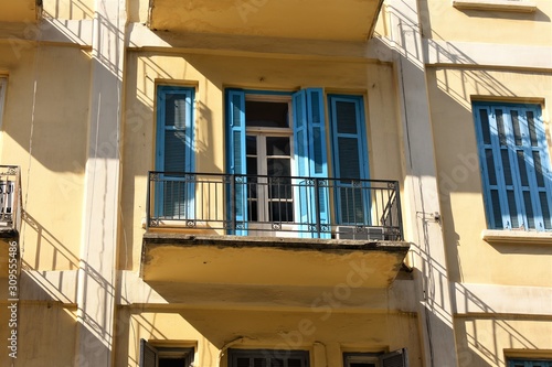 balcony and blue wood blinds in an old building in Beirut