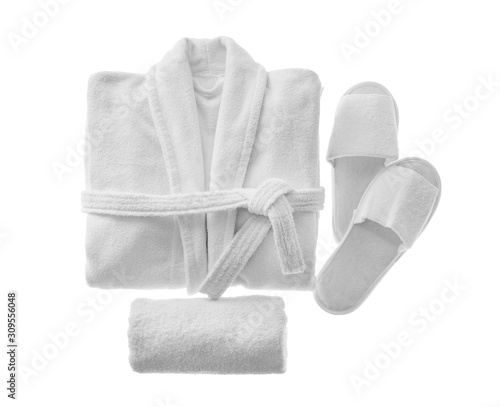 Fototapeta Clean folded bathrobe, slippers and towel isolated on white, top view