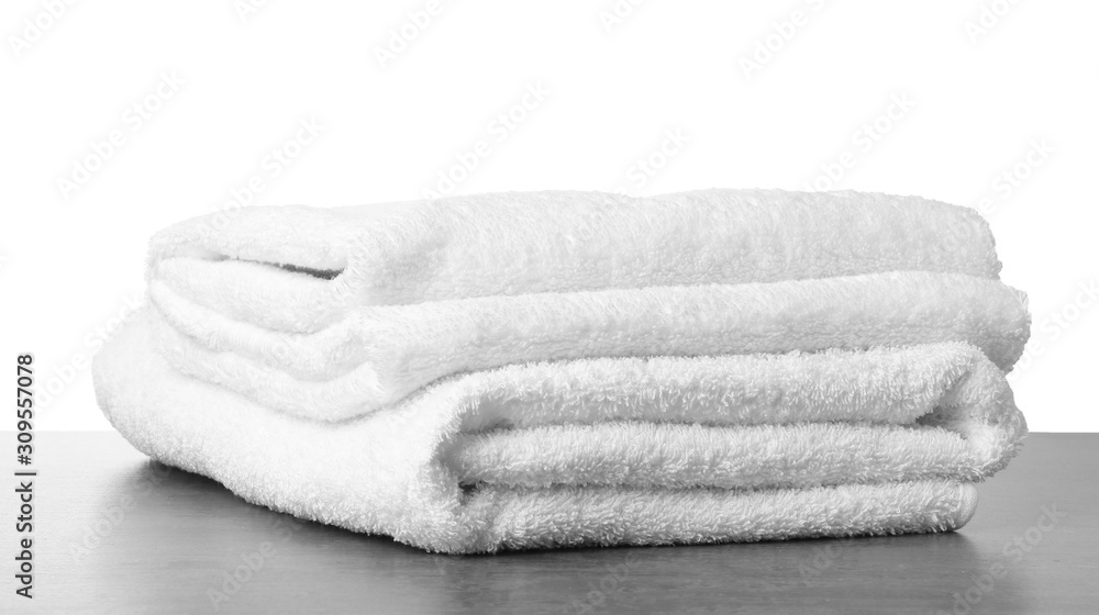 Folded fresh clean towels for bathroom on table against white background. Space for text Folded fresh clean towels for bathroom on table against white background. Space for text