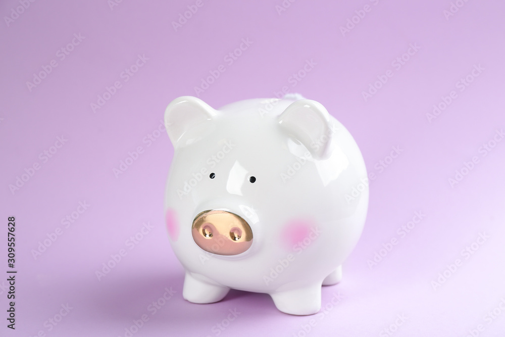 Cute white piggy bank on violet background