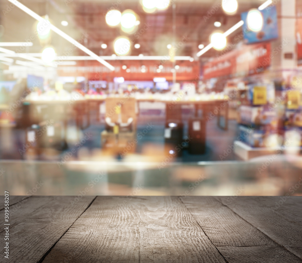 Empty wooden surface and blurred view of shopping mall. Space for design