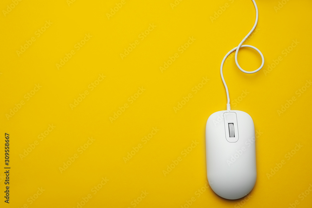 Wired computer mouse on yellow background, top view. Space for text Wired computer mouse on yellow background, top view. Space for text