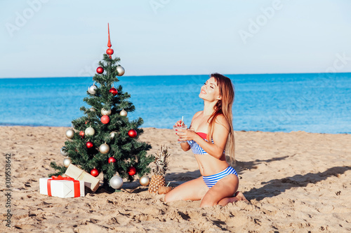 girl in a bathing suit on a beach new year's Eve in the tropics photo