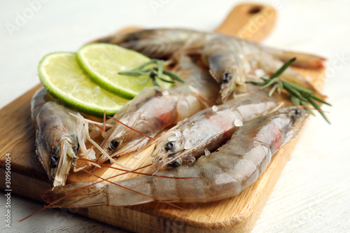 Fresh raw shrimps on white wooden table, closeup