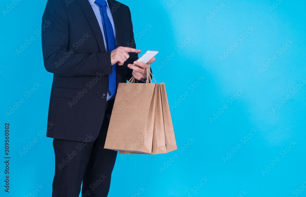 businessman with mobile phone and bags, online shopping concept businessman with mobile phone and bags, online shopping concept