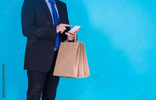 businessman with mobile phone and bags, online shopping concept