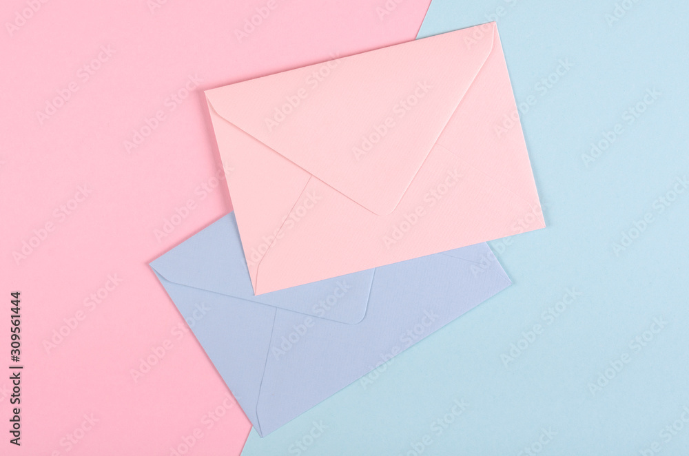 Blue paper envelope composition on pink background.