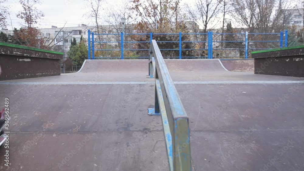 Girl riding a scooter at a skatepark. Girl riding a scooter at a skatepark.
