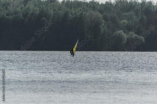 Windsurfer swimming in a lake