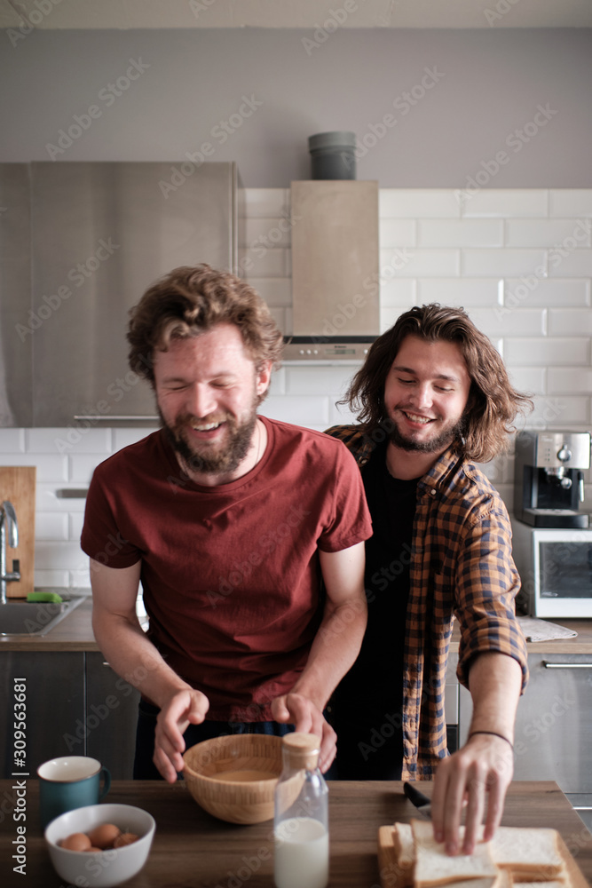 Gay couple goofying at the kitchen while making breakfast Gay couple goofying at the kitchen while making breakfast