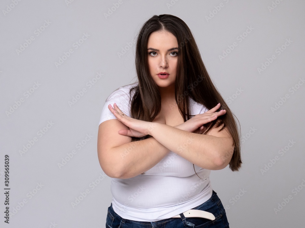 Plus Size Model with long hair gesturing no signal in studio. Plus Size Model with long hair gesturing no signal in studio.