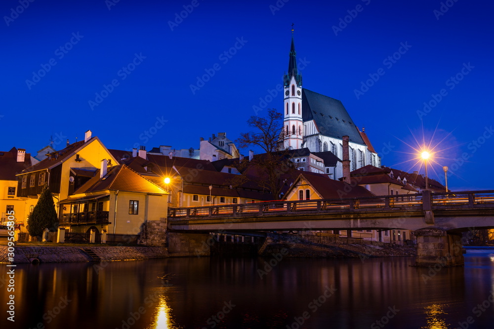 Catholic church of St. Vitus and Vltava river at night. Historical center of Cesky Krumlov. Czech republic.
