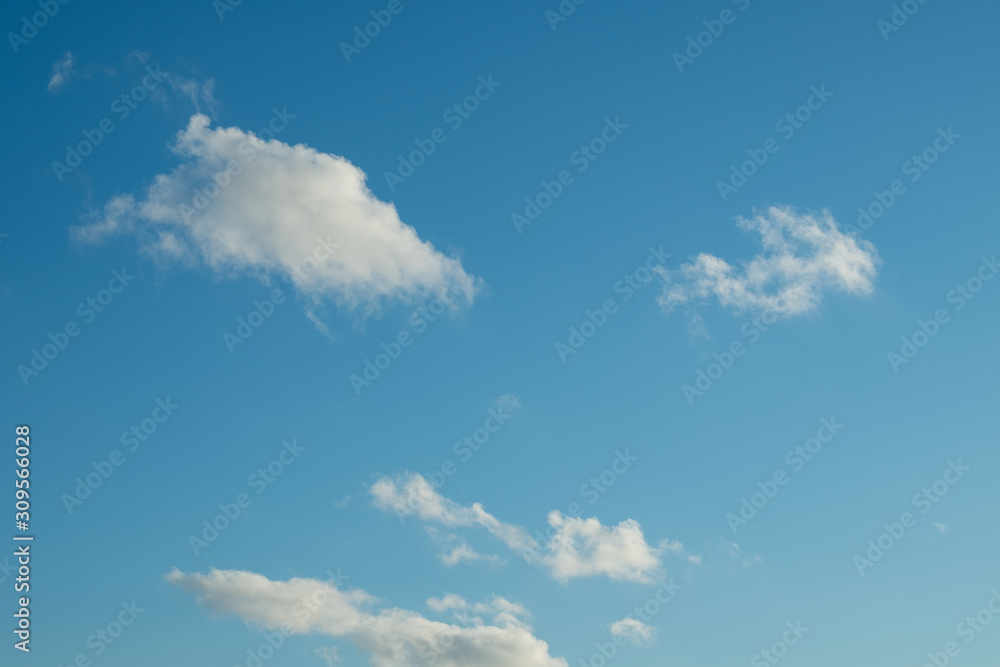 Blue sky with fluffy clouds. Cloudy sky background. Clouds on the blue sky.
