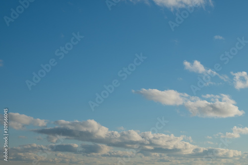 Blue sky with fluffy clouds. Cloudy sky background. Clouds on the blue sky.