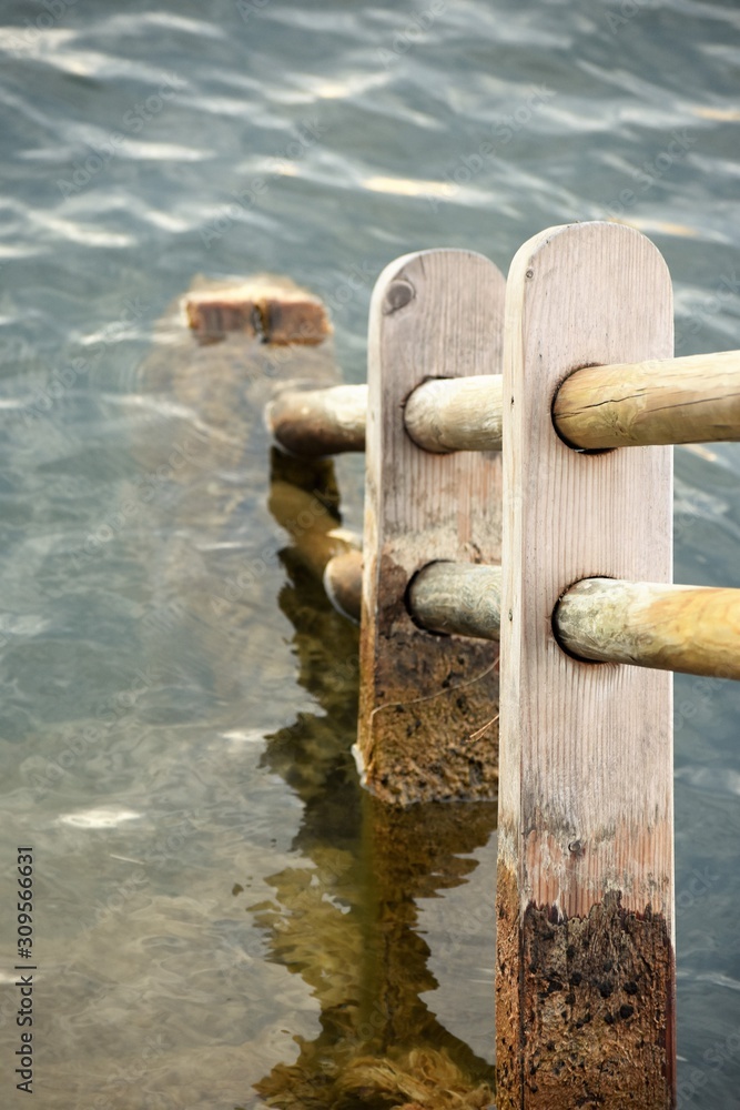 Wooden rail leading down into water Wooden rail leading down into water