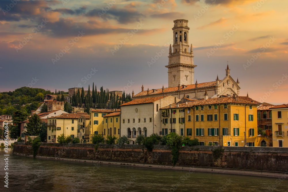 View of the historic city center along Adige river at sunset in Verona, Italy.