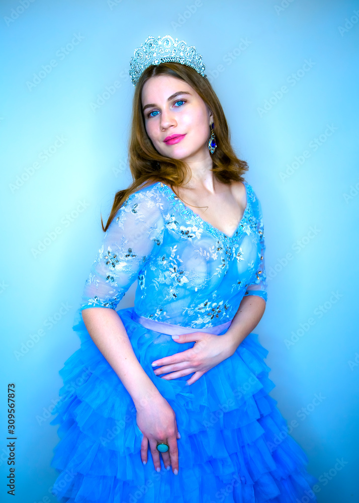 Young beautiful girl with blue eyes in a blue festive dress. Girl with ...