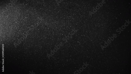 Natural Organic Dust Particles Floating On Black Background. Glittering Sparkling Particles Randomly Spin In The Air With Bokeh. Dynamic Particles With Fast And Slow Motion. Shimmering Dust In Space. photo