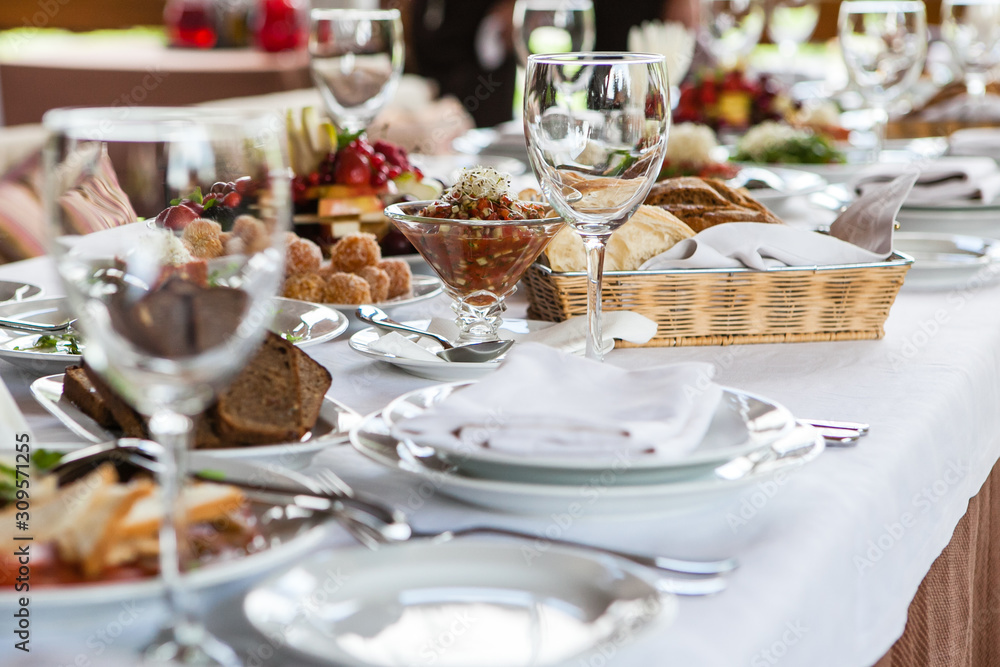 Served for banquet restaurant table with dishes, snack, wine glasses Served for banquet restaurant table with dishes, snack, wine glasses