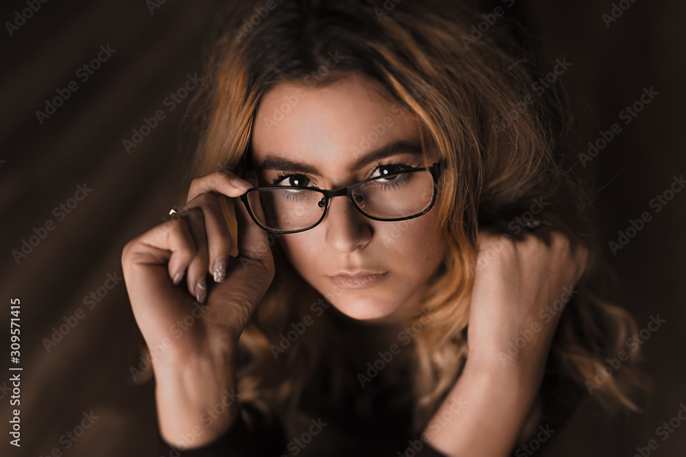 Beautiful young women poses with glasses and her favorite books. Shiny pure skin, natural makeup Beautiful young women poses with glasses and her favorite books. Shiny pure skin, natural makeup