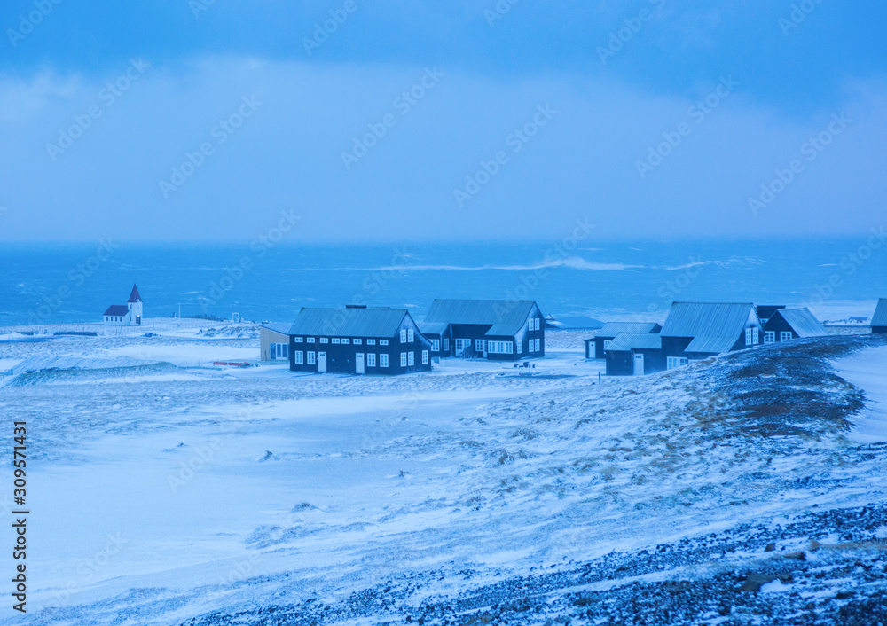 Small Icelandic village (near  Olafsvik) by the ocean during the winter snowstorm, Snaefellsnes,  Iceland.