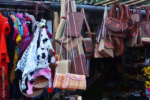 фотографія Close up of a shop displaying varieties of handicraft local goods like bags, sha