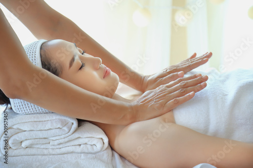 Young woman receiving rubbing and kneading of muscles and joints of the body with the hands