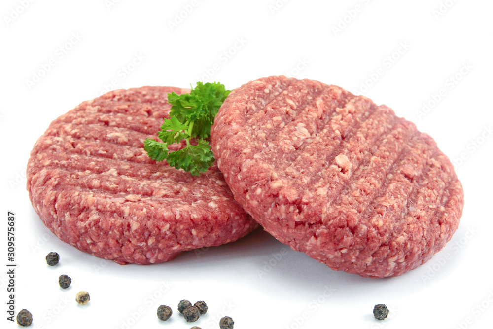 two minced steaks of raw beef on a white background two minced steaks of raw beef on a white background