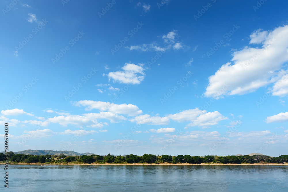 The image is for the background, light blue sky and clouds with a slight reflection of the river.