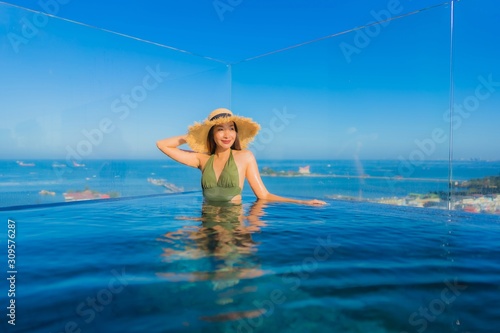 Beautiful young asian women happy smile relax around outdoor swimming pool in hotel resort for travel in holiday vacation
