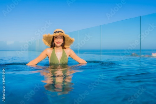 Beautiful young asian women happy smile relax around outdoor swimming pool in hotel resort for travel in holiday vacation